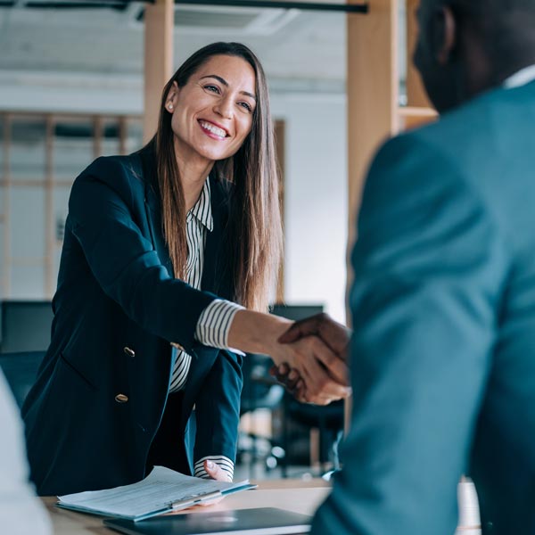 woman shaking hands with man